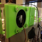 Rear view of the exhaust fan assembly, showing the modified 3D-printed sheet instead of a piece of plexiglass. The fan and filter is held on inductively by magnets.