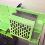 Overhead view of filtered 80mm exhaust fan showing carbon filter section with grille followed by black 80mm fan and then the plastic wall.