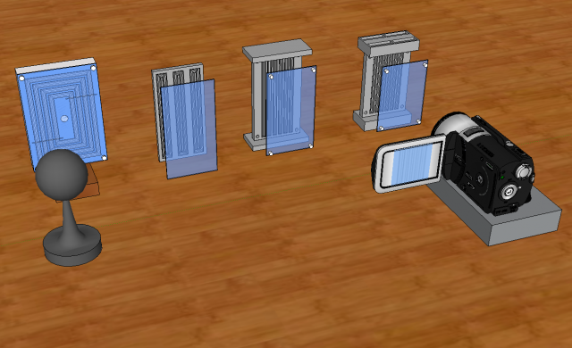 Four prototypes of the flytrack starting with a raceway approach and then leading to the final design with a sample video camera for recording.