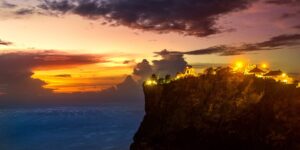 Village lights on a cliff at dusk